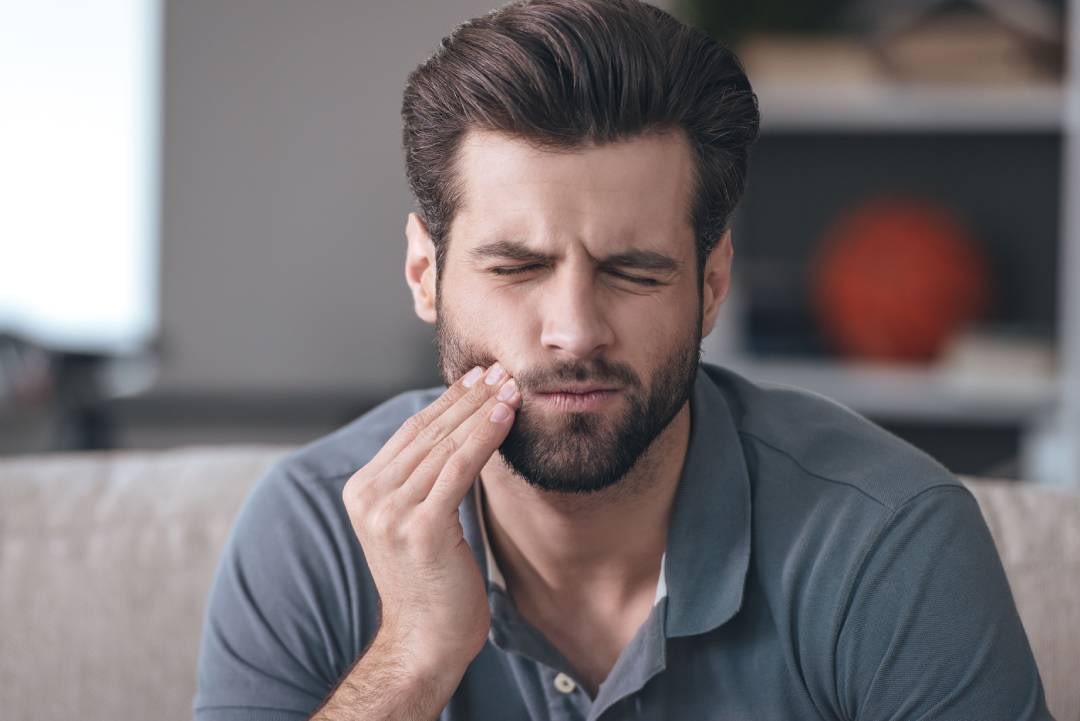 a man with pain after dental filling