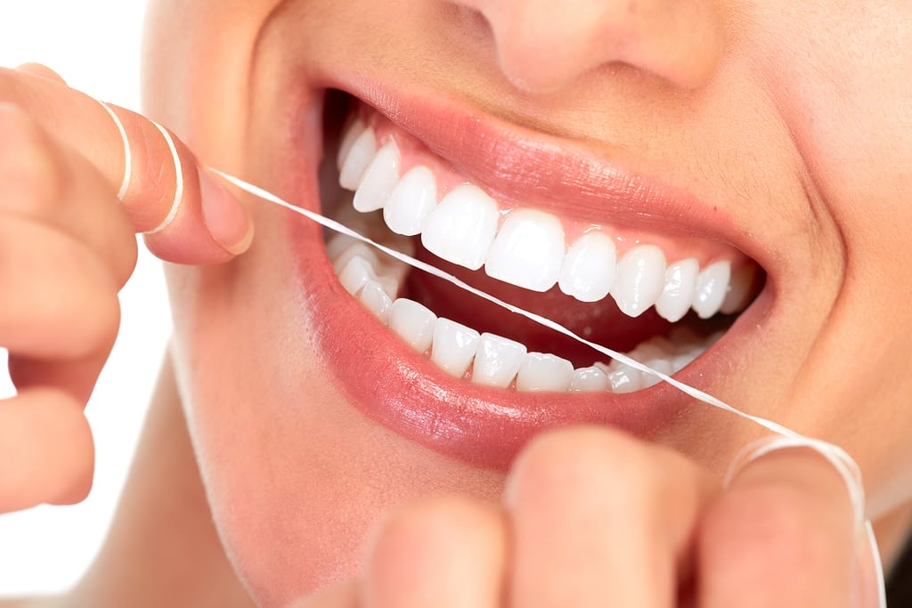 lady flossing her teeth